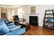 Spacious living area with hardwood floors, a fireplace, and staircase access at 2217 Magnolia Tree Ln, Durham, NC 27703