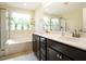 Relaxing main bathroom featuring double sinks, a soaking tub and a separate shower at 2217 Magnolia Tree Ln, Durham, NC 27703