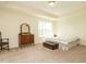 Comfortable main bedroom with carpet, a dresser and a large window at 2217 Magnolia Tree Ln, Durham, NC 27703