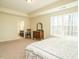 Spacious main bedroom with carpet flooring, ensuite bathroom, and large window at 2217 Magnolia Tree Ln, Durham, NC 27703