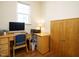 Cozy home office features a wooden desk, computer and natural lighting at 2217 Magnolia Tree Ln, Durham, NC 27703