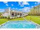 Beautiful backyard with well-manicured lawn, patio, and a luxurious hot tub perfect for outdoor relaxation at 2223 Winston Cir, Apex, NC 27502