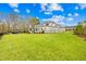 Beautifully landscaped backyard featuring lush green grass and a privacy fence at 2223 Winston Cir, Apex, NC 27502