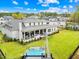 Expansive backyard featuring a covered patio, lush lawn, and a luxurious hot tub at 2223 Winston Cir, Apex, NC 27502