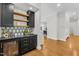 Modern bar area features custom cabinets, open shelves, and a built-in wine fridge at 2223 Winston Cir, Apex, NC 27502