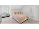 Bright bedroom with light pink bedding, comfortable couch, and attached bathroom at 2223 Winston Cir, Apex, NC 27502