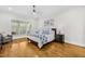 Beautiful bedroom features hardwood floors, large window and ceiling fan at 2223 Winston Cir, Apex, NC 27502