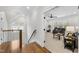 Upstairs hallway and bonus room features plush carpet, ceiling fan, and plenty of sunlight at 2223 Winston Cir, Apex, NC 27502