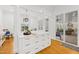 Transitional dining area features custom built-in cabinets with gold hardware, hardwood floor and plenty of sunlight at 2223 Winston Cir, Apex, NC 27502