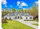 Stunning white home featuring a manicured lawn, dormer windows, and a spacious driveway at 2223 Winston Cir, Apex, NC 27502