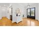 Bright foyer with hardwood floors, decorative table, mirror, and a modern chandelier at 2223 Winston Cir, Apex, NC 27502