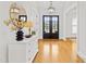 Inviting foyer featuring hardwood floors, a decorative mirror, and a stylish light fixture at 2223 Winston Cir, Apex, NC 27502