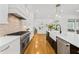 Gourmet kitchen features stainless steel appliances, subway tile backsplash, and island seating at 2223 Winston Cir, Apex, NC 27502