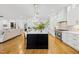 Open kitchen flows to living space with stainless appliances, center island, and bar seating at 2223 Winston Cir, Apex, NC 27502