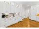 Stylish kitchen includes custom cabinetry, elegant lighting, and hardwood flooring at 2223 Winston Cir, Apex, NC 27502