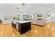 Open concept kitchen and living area features a large island and comfortable seating at 2223 Winston Cir, Apex, NC 27502