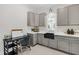 A well-equipped laundry room with gray cabinets and a black sink at 2223 Winston Cir, Apex, NC 27502
