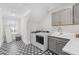 Bright laundry room with patterned floors, modern appliances, and ample storage at 2223 Winston Cir, Apex, NC 27502