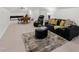 Open living area with games table, leather sofa, and soft carpet at 2223 Winston Cir, Apex, NC 27502