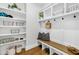Organized mudroom with shelves, hooks, a bench, and decorative baskets at 2223 Winston Cir, Apex, NC 27502