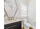 Modern powder room with unique mirror, decorative sink, and stylish fixtures at 2223 Winston Cir, Apex, NC 27502