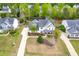 Aerial view of a home with a long driveway, spacious yard and a basketball court at 240 Swann Trl, Clayton, NC 27527