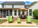 Outdoor deck area features a dining table set with an umbrella and Adirondack chairs at 240 Swann Trl, Clayton, NC 27527