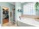 Well-appointed bathroom featuring a soaking tub and walk-in closet at 240 Swann Trl, Clayton, NC 27527