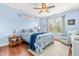 Serene bedroom with blue walls, a comfortable bed, and a cozy sitting area for relaxation at 240 Swann Trl, Clayton, NC 27527