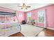 Pink bedroom featuring a bunk bed, hardwood floors, and a sunny window at 240 Swann Trl, Clayton, NC 27527