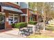 Exterior of commercial space with outdoor seating, mature landscaping, and pedestrian walkway at 240 Swann Trl, Clayton, NC 27527