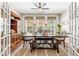 Spacious dining room with wooden table and chairs, bathed in natural light from large windows at 240 Swann Trl, Clayton, NC 27527