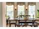 Bright dining room with a rustic table, natural light, and decorative lighting at 240 Swann Trl, Clayton, NC 27527