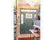 View of the front door with wainscoting, elegant chandelier, and hardwood floors at 240 Swann Trl, Clayton, NC 27527