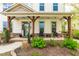 Inviting front porch with stone accents, seating, and views of the landscaped front yard at 240 Swann Trl, Clayton, NC 27527