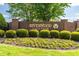 Entrance to Riverwood Golf Club featuring brick sign with mature landscaping at 240 Swann Trl, Clayton, NC 27527