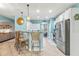 Bright kitchen with a bar, stainless appliances, and a view into the living room at 240 Swann Trl, Clayton, NC 27527