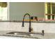 Close-up of granite countertop and a modern black and gold faucet at 240 Swann Trl, Clayton, NC 27527