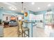 Open-concept kitchen with breakfast bar and stainless appliances next to the living area at 240 Swann Trl, Clayton, NC 27527