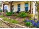 Lush front yard with blooming flowers, greenery, and retaining wall at 240 Swann Trl, Clayton, NC 27527