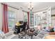 Spacious living room with home office, featuring hardwood floors, large windows, and stylish furniture at 240 Swann Trl, Clayton, NC 27527