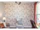 Bright living room with floral wallpaper, complemented by light colored seating and natural light at 240 Swann Trl, Clayton, NC 27527