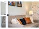 Cozy living room with plush gray sofa, complemented by colorful pillows and natural light at 240 Swann Trl, Clayton, NC 27527