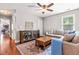 Spacious living room featuring a sectional sofa, wooden storage cabinet and a colorful area rug at 240 Swann Trl, Clayton, NC 27527