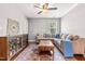 Inviting living room featuring a sectional sofa, wooden storage cabinet and a colorful area rug at 240 Swann Trl, Clayton, NC 27527