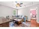 Comfortable living room featuring a large sectional sofa, a wooden coffee table, and a vibrant area rug at 240 Swann Trl, Clayton, NC 27527