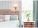 Bright bedroom featuring a bedside table, wallpaper and natural light at 240 Swann Trl, Clayton, NC 27527