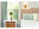 Charming bedroom decor with an elegant bedside table and window view at 240 Swann Trl, Clayton, NC 27527