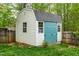 Charming backyard shed with a barn-style roof and double doors, nestled in a green lawn at 240 Swann Trl, Clayton, NC 27527