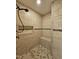 Modern shower with tile surround and built-in niche, paired with mosaic tile flooring at 240 Swann Trl, Clayton, NC 27527